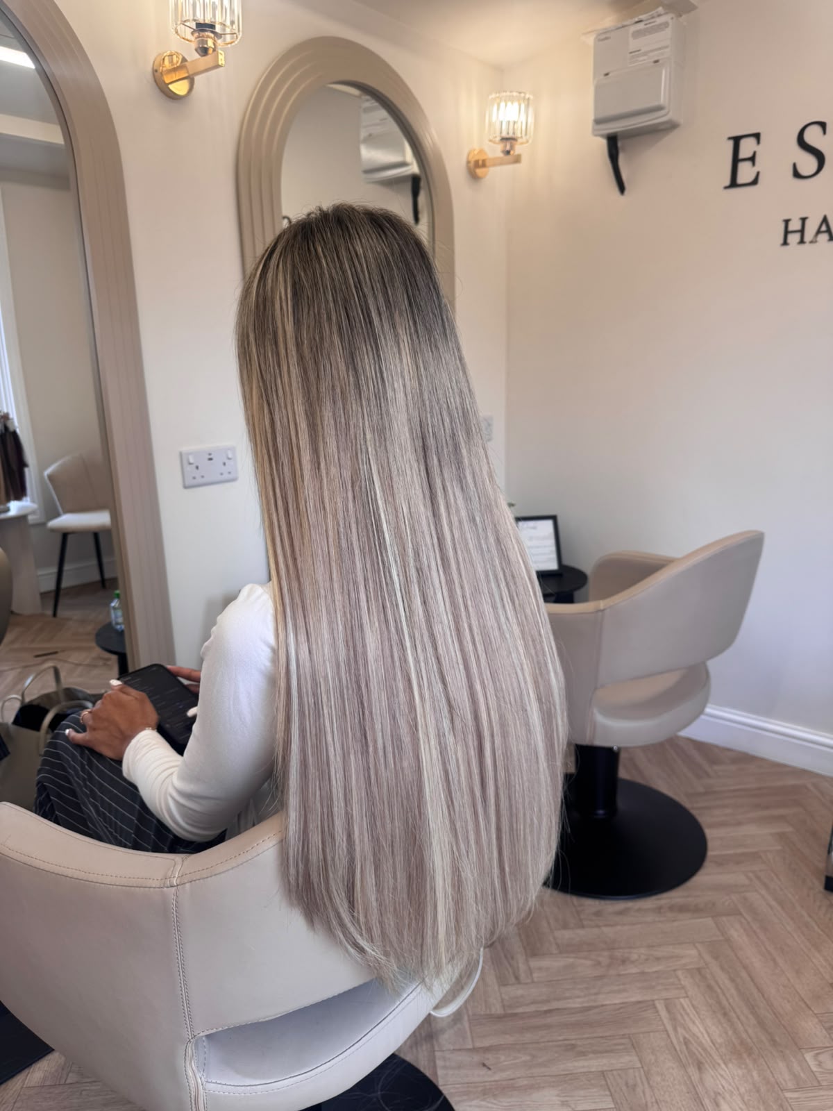 Long icy-blonde balayage with hybrid hair extensions at Essence in Luton