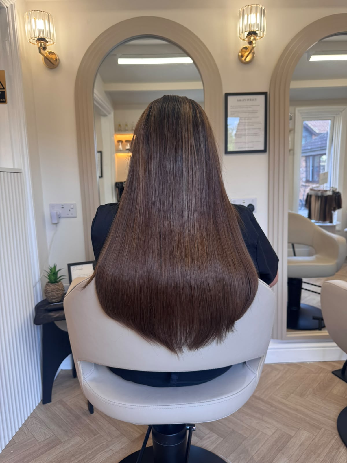 Long, sleek brunette hair with LA Weave extensions